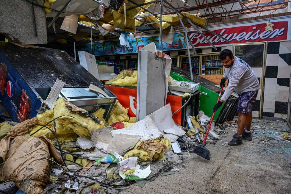 On Thursday, a man cleaned the gas station in Lakewood Park, which suffered badly in the hurricane.