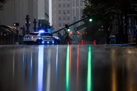 A police car and a broken traffic light pole in Orlando on Thursday, October 10.