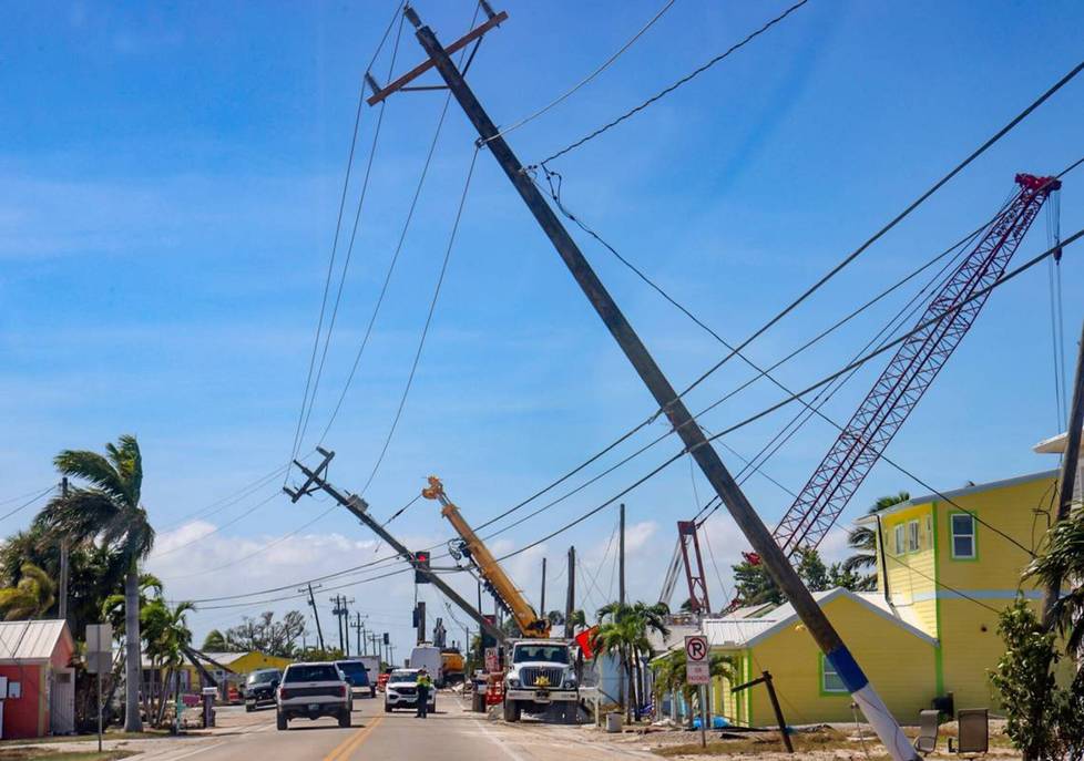 In Matlacha, cars were shuttling on Thursday amidst the hurricane damage. About 12 hours after the hurricane, power lines were still down and residents were trying to evacuate their homes.